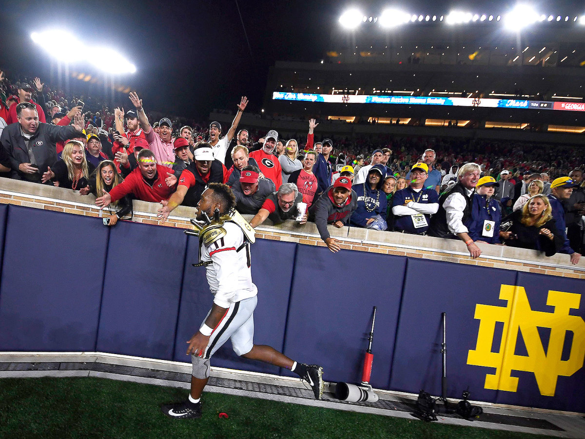 Georgia's Davin Bellamy celebrates with Bulldogs fans after UGA defeated Notre Dame on Sept. 9, 2017.
